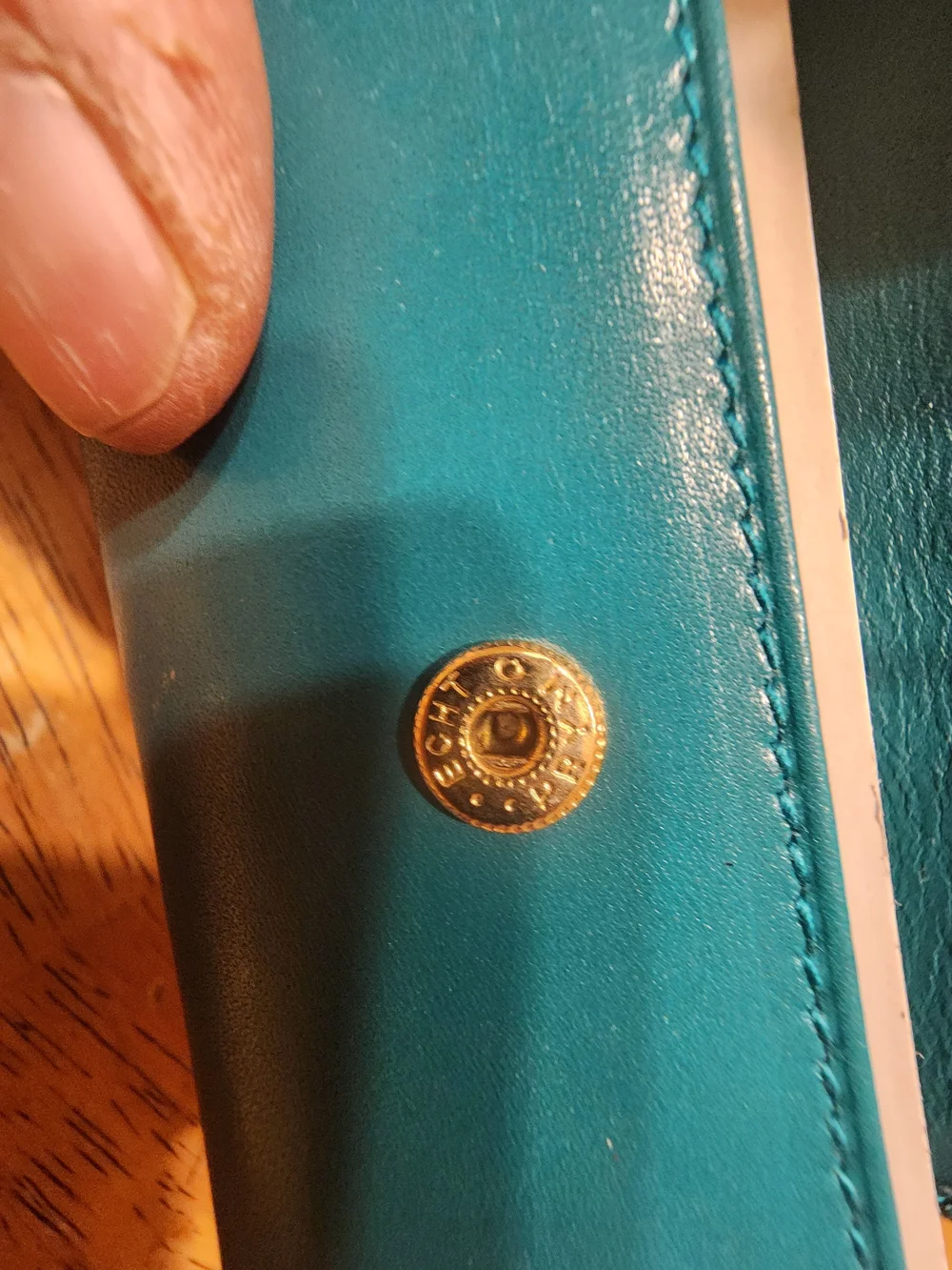 vintage Gucci teal leather key case featuring a distinctive cabochon stone